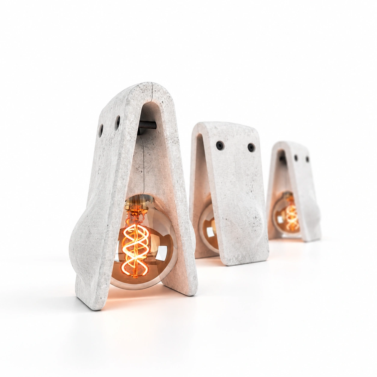 Trois lampes Jusa montrant les ouvertures du béton autour de l’ampoule